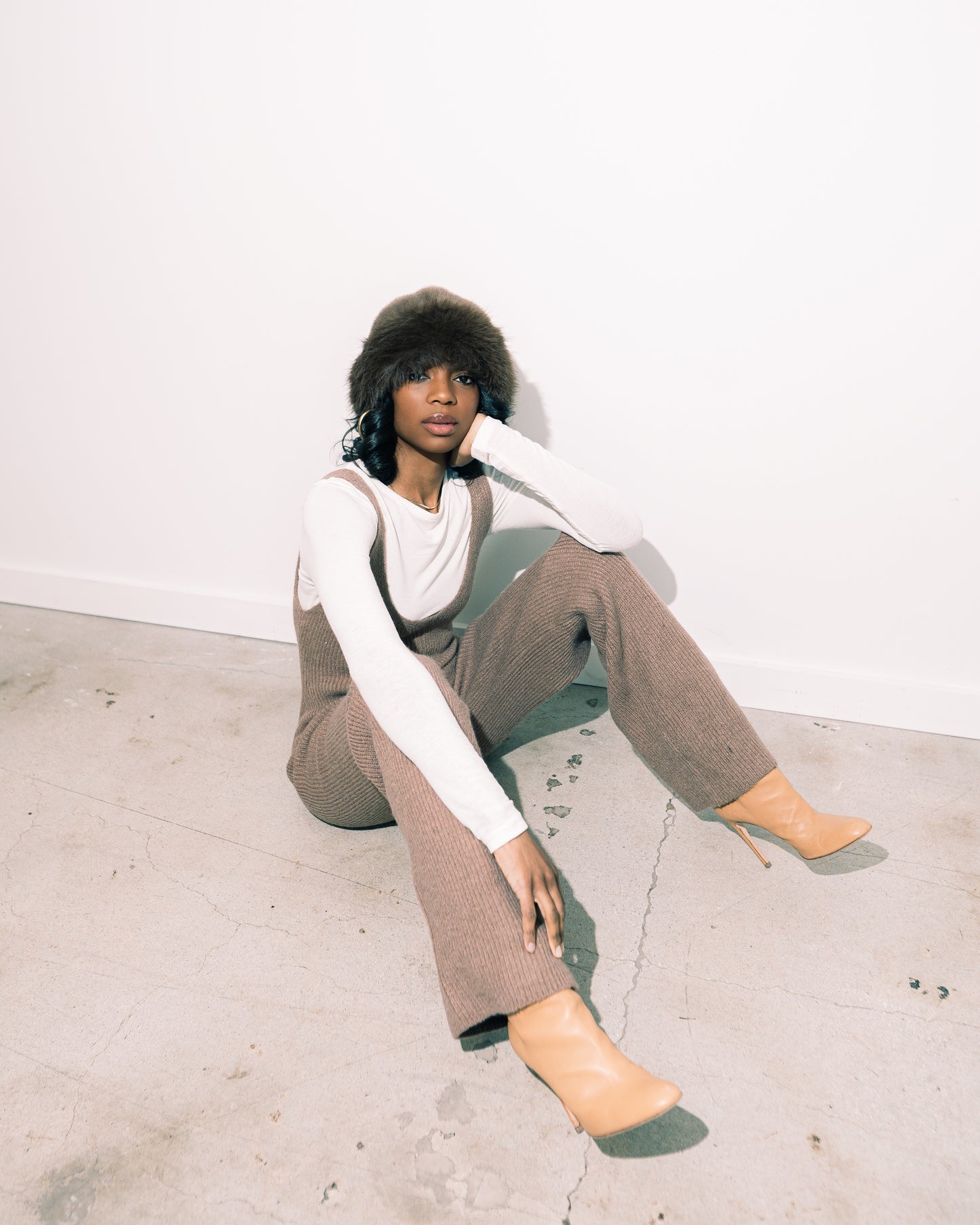 Too Cozy Jumpsuit  model sitting down with heeled boot